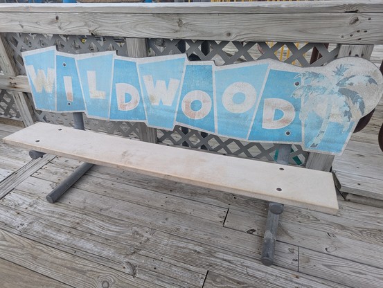Faded bench with wildwood on it.